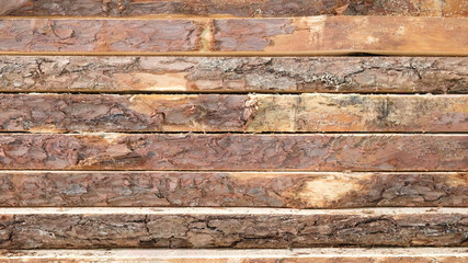 Naklejka premium stack of raw boards as sawmill products, wooden natural texture background