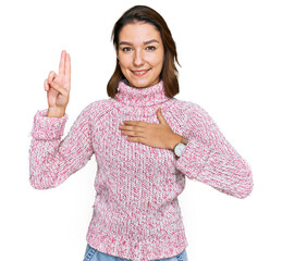Young caucasian girl wearing wool winter sweater smiling swearing with hand on chest and fingers...