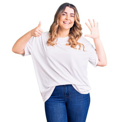 Young caucasian woman wearing casual clothes showing and pointing up with fingers number six while smiling confident and happy.
