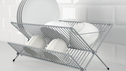 Dish drainer with dishes, cups and bowls on white sink counter.
