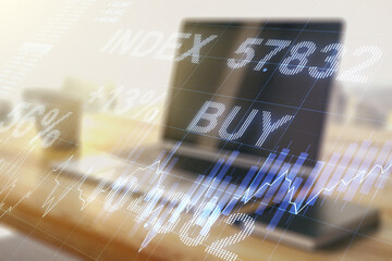 Double exposure of abstract creative financial chart and modern desktop with laptop on background, research and strategy concept