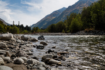 Fototapeta premium stones lying on the bank of a mountain river in autumn