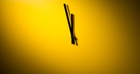 Abstract clock - modern clock hands showing time under dramatic light on a yellow background. - 687539364