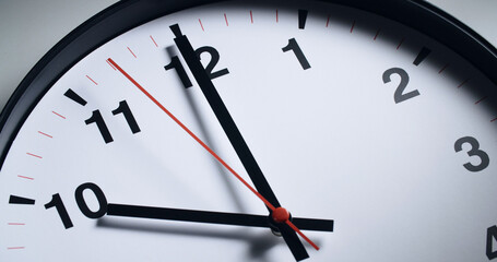 Closeup shot of a wall clock with clock hands showing 10 o'clock