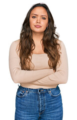 Fototapeta premium Young hispanic girl wearing casual clothes skeptic and nervous, disapproving expression on face with crossed arms. negative person.