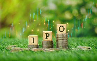Rows of money coins stacks with IPO word on wooden cube and candlestick charts in the garden sunshine day background for Initial Public Offering, Increased investment concept, economic concept. - obrazy, fototapety, plakaty
