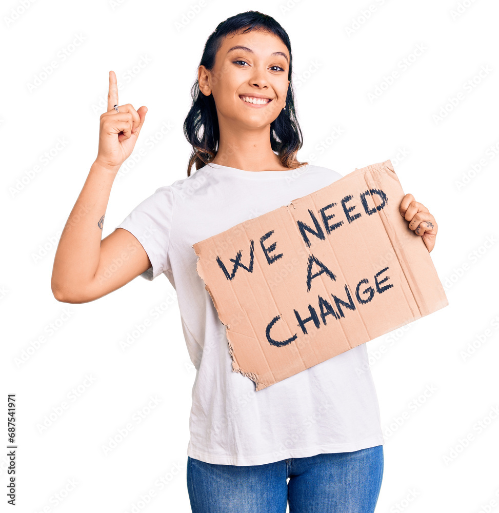 Sticker young woman holding we need a change banner surprised with an idea or question pointing finger with 