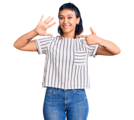 Young woman wearing casual clothes showing and pointing up with fingers number seven while smiling confident and happy.