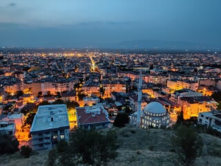 Fototapeta na wymiar The city of Salihli at sunset, city lights, mosque, turkish city, türkiye