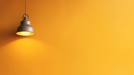 Obraz premium A lamp hangs on a yellow wall and illuminates it, space for text or presentation