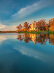 blue hour and golden light on old church on lake