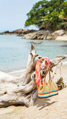 Fototapeta na wymiar Beach bag and coconut at sea Selective focus Travel. Packed beach bag on beach. Tourist belongings on beach.
