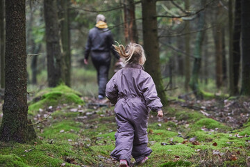 Mother with daughter walk in the forest in Denmark