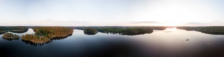 Panoramic summer sunset view of forest lake