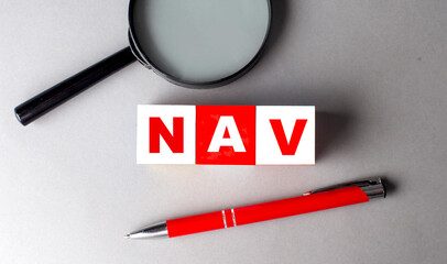 NAV word on wooden cubes with pen and magnifier