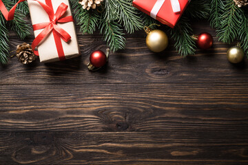 Christmas presents and holiday decorations on wooden background. Flat lay image.