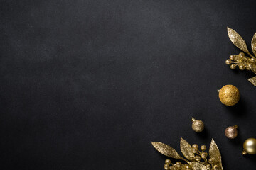 Christmas gold decorations on black. Flat lay image with copy space.