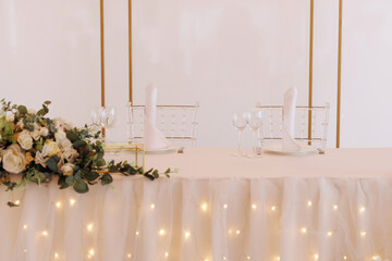 Elegant wedding table setting with white flowers and candles. Concept for wedding planners, event...