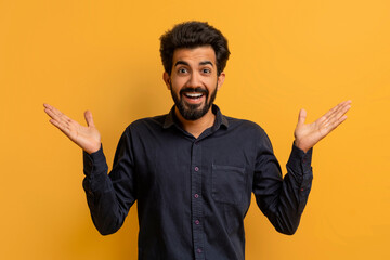 Portrait Of Surprised Young Indian Man Spreading Hands With Excitement