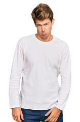Obraz premium Handsome caucasian man wearing casual white sweater depressed and worry for distress, crying angry and afraid. sad expression.