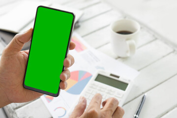 empty smartphone with a green screen at the coffee shop and a Financial graph chart. For the creators to put in additional images. Financial development, Banking Account, Statistics