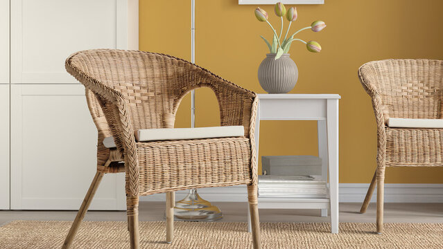 Closeup of rattan woven armchairs with white cushions in a yellow room.