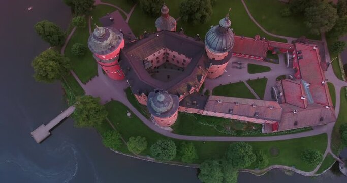 Aerial Tilt Up Shot Of Domes On Famous Medieval Castle On Green Landscape At Sunset - Mariefred, Sweden