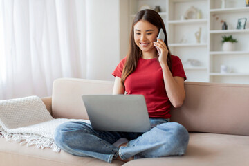 Online Work. Asian Female Working With Laptop And Cellphone At Home