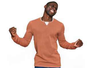Young african american man wearing casual clothes very happy and excited doing winner gesture with arms raised, smiling and screaming for success. celebration concept.