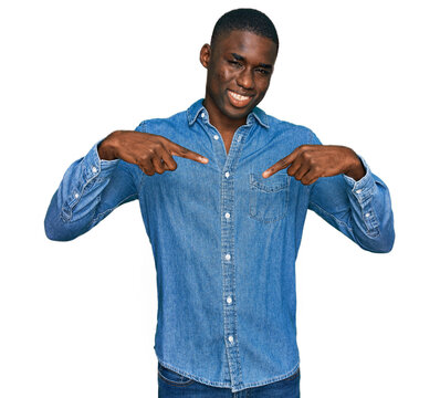 Young african american man wearing casual clothes looking confident with smile on face, pointing oneself with fingers proud and happy.