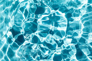 Storm in the water. Waves, ripples and bubbles. Pool, river, ocean. Blue textured background for your design. Selective focus, defocus