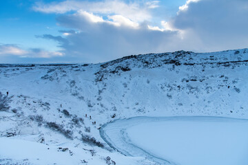 High angle view of Kerid volcanic crater lake in winter with snow on south Iceland, along the...