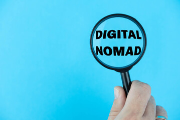 Digital Nomad lifestyle, with a magnifying glass focused on the term “Digital Nomad”. Concept...