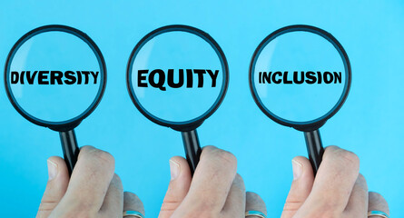 Diversity, Equity, Inclusion (DEI) concept, under magnifying glass focused on the term. Fair...