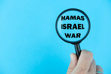Conflict between Hamas and Israel, with a magnifying glass focused on “Hamas Israel War”....