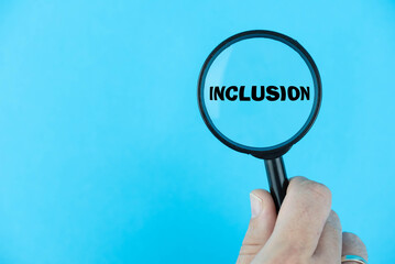 Inclusion, under magnifying glass focused on the term. A visual representation of a business embracing diversity, fostering a culture of belonging, and ensuring everyone's meaningful participation
