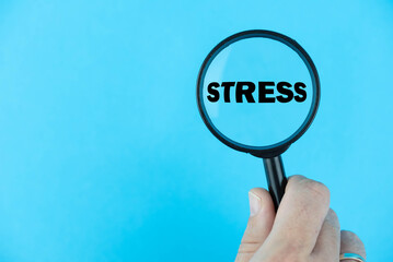 Stress, under magnifying glass focused on the term. A visual representation of the impact, management, and awareness surrounding stress, emphasizing mental health well-being strategies.