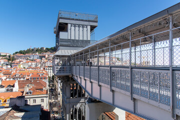 Lisbon, Portugal-October 2022; High level view of Santa Justa Lift, a cast-iron elevator with ornamental iron work details built in 1902 to connect lower streets with Carmo Square - obrazy, fototapety, plakaty