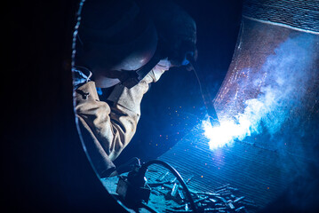 Welding steel structures and bright sparks in steel construction industry.