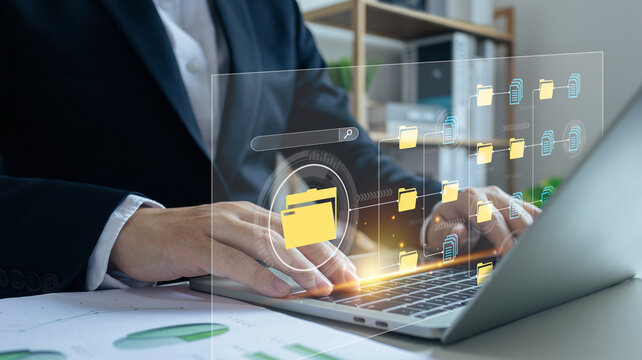 Document Management System (DMS),Businessman using a laptop searching folder and managing files paperwork.Software for archiving,share online database server, administration employee in enterprise.