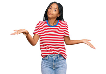Beautiful hispanic woman wearing casual clothes clueless and confused expression with arms and...