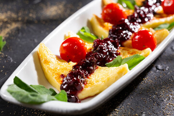 Grilled papialpa cheese with red fruit jam with cherry tomatoes and basil
