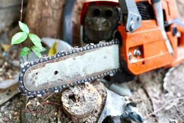 Chain saw, power saw, sawing machine ,Modern chain saw and firewood,closeup.
