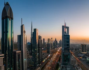 Foto auf Acrylglas High view point of Sheikh Zayed road in rush hour, Dubai, UAE, in the blue hour at dusk with Burj Khalifa in the distance and modern skyscrapers in the foreground © John