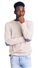 Young african american man wearing casual clothes looking stressed and nervous with hands on mouth...