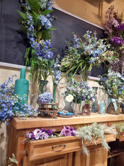 floral arrangement on the table made of blue and purple flowers, part of the interior, cozy corner in the room