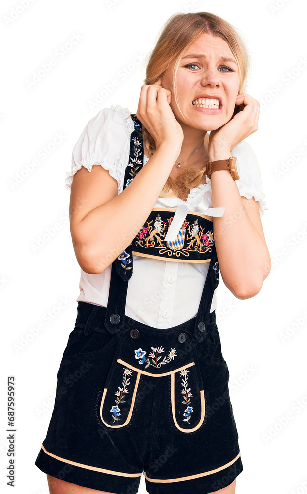 Wall mural Young beautiful blonde woman wearing oktoberfest dress covering ears with fingers with annoyed expression for the noise of loud music. deaf concept.