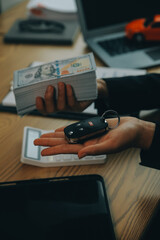 Salesman send key to customer after good deal agreement, successful car loan contract buying or selling new vehicle.