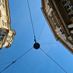 Fototapeta na wymiar street light hanging on cables in the city of Vienna