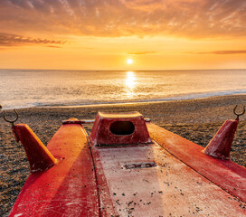 beautiful cloudy morning landscape with diving mask on a red old boat on foreground, sand beach,...
